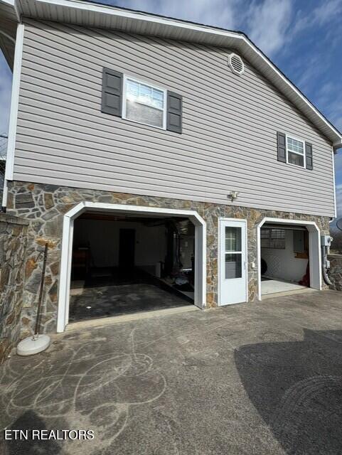 view of side of home featuring a garage