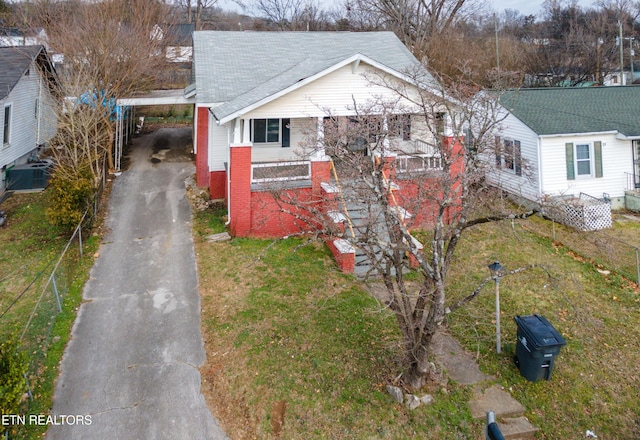 view of home's exterior with cooling unit, a carport, and a yard