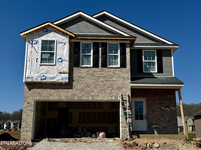 view of front of house with brick siding and a garage