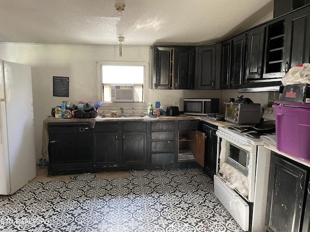 kitchen with sink, cooling unit, a textured ceiling, and white appliances