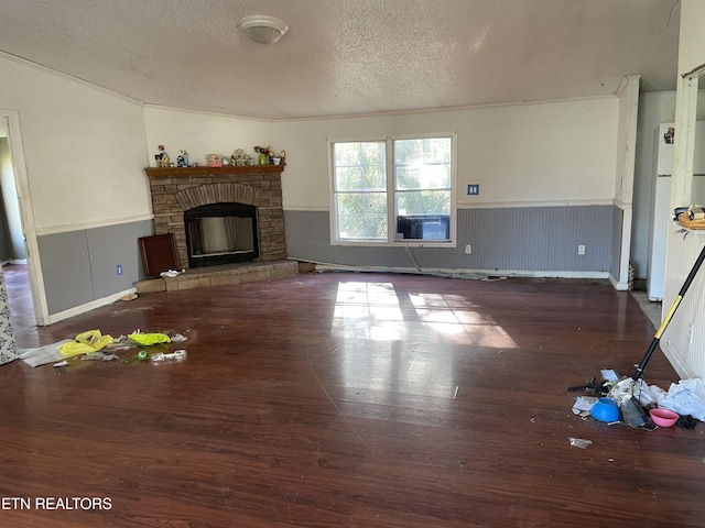 unfurnished living room with dark hardwood / wood-style flooring, a fireplace, and a textured ceiling