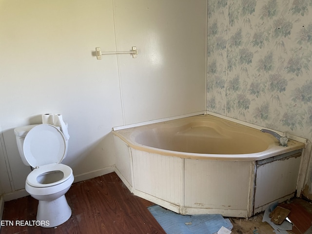 4589 Mount Carmel Rd, Camden, TN 38320 - full bathroom featuring toilet, wallpapered walls, wood finished floors, and a bath