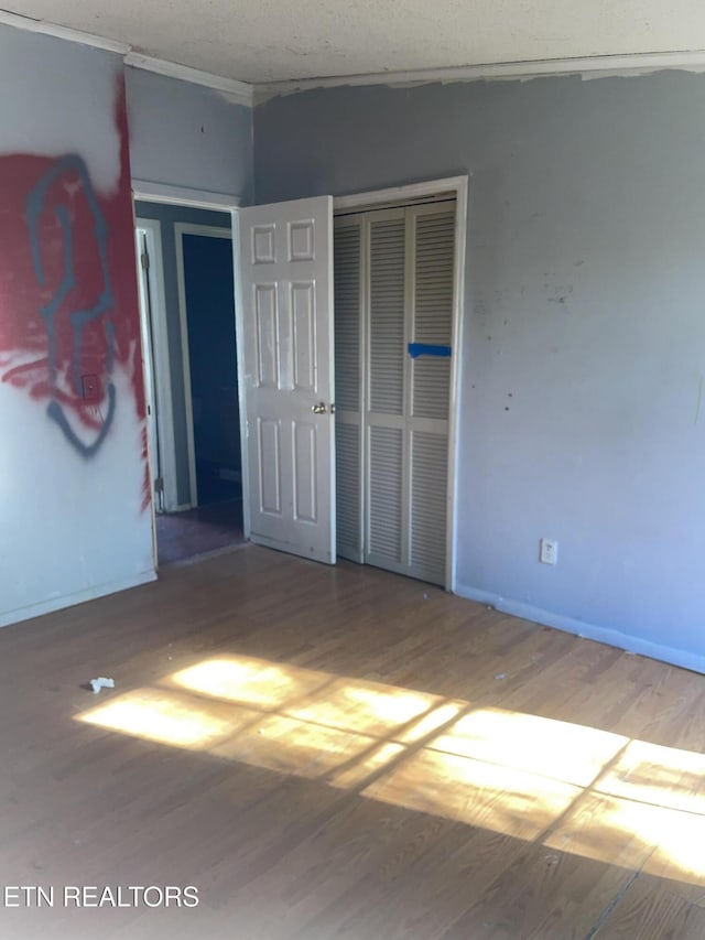 4589 Mount Carmel Rd, Camden, TN 38320 - unfurnished bedroom featuring a closet, baseboards, and wood finished floors
