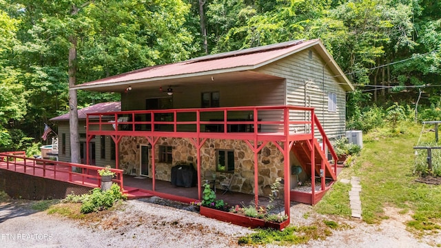 1731 Vonore Rd, Loudon, TN 37774 - view of front of property featuring a deck, metal roof, stone siding, and a forest view