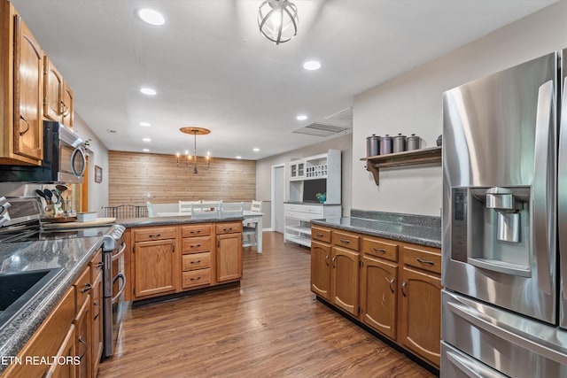 1731 Vonore Rd, Loudon, TN 37774 - kitchen featuring appliances with stainless steel finishes, a peninsula, recessed lighting, dark wood finished floors, and brown cabinets