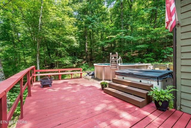 1731 Vonore Rd, Loudon, TN 37774 - wooden terrace with a hot tub, an outdoor pool, a wooded view, and a fire pit