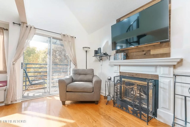 sitting room with vaulted ceiling and hardwood / wood-style floors