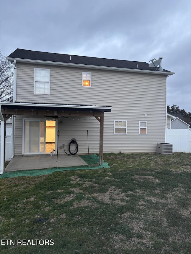 back of house featuring a patio and a yard