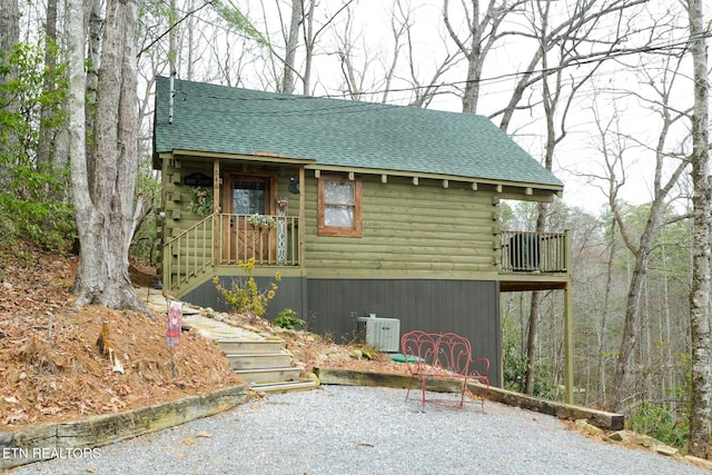 view of side of property featuring a balcony and central AC unit