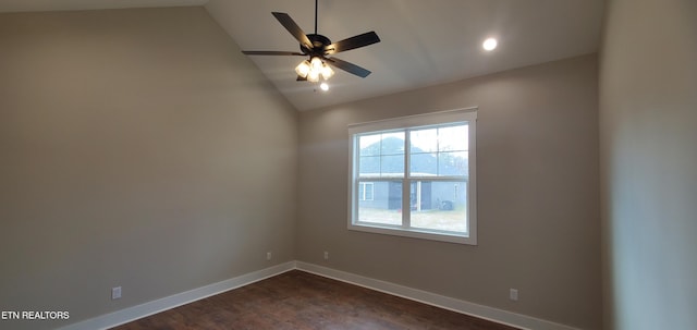 empty room with lofted ceiling, dark hardwood / wood-style floors, and ceiling fan