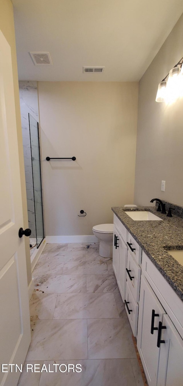 bathroom featuring walk in shower, vanity, and toilet