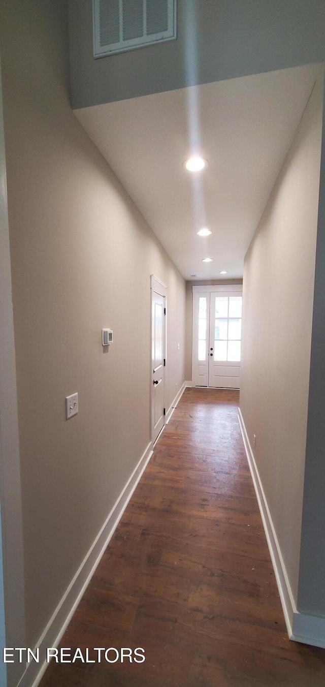 hallway featuring dark hardwood / wood-style flooring