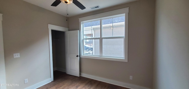 unfurnished bedroom featuring dark hardwood / wood-style floors and ceiling fan