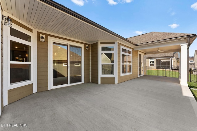 view of patio featuring fence and a ceiling fan