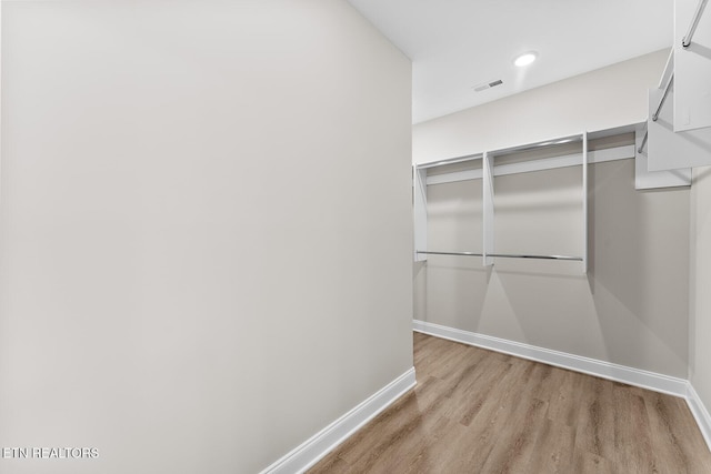 walk in closet featuring light wood-type flooring and visible vents