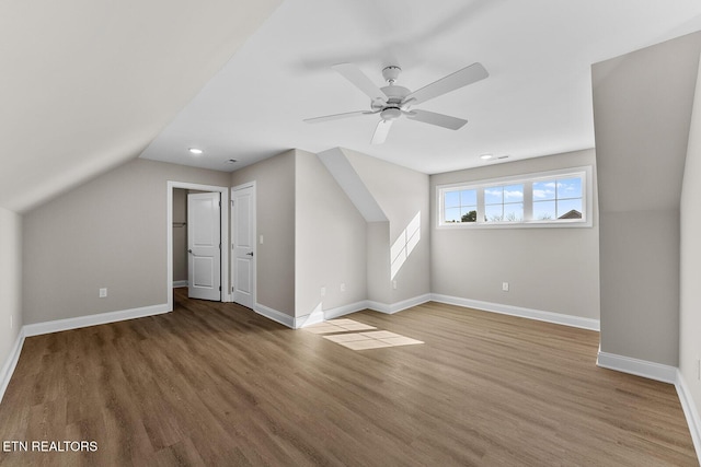 bonus room featuring ceiling fan, vaulted ceiling, baseboards, and wood finished floors