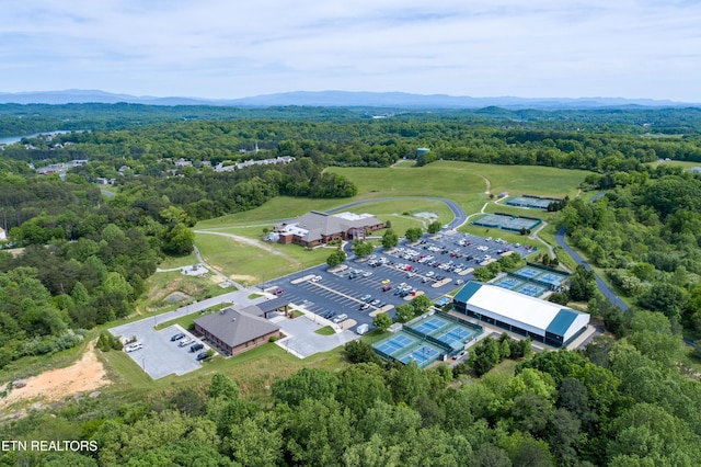 bird's eye view with a wooded view