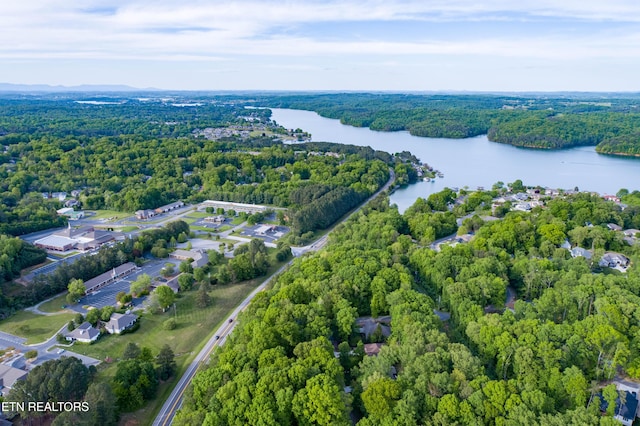 bird's eye view with a forest view and a water view