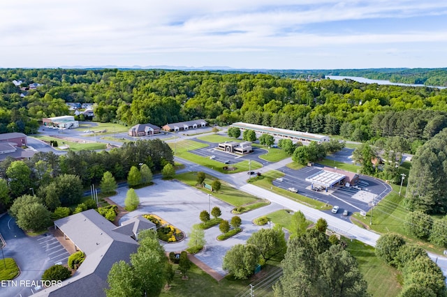 drone / aerial view featuring a forest view