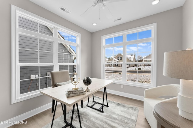 office space with light wood finished floors, plenty of natural light, and baseboards