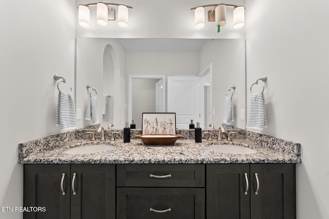 full bath with double vanity and a sink