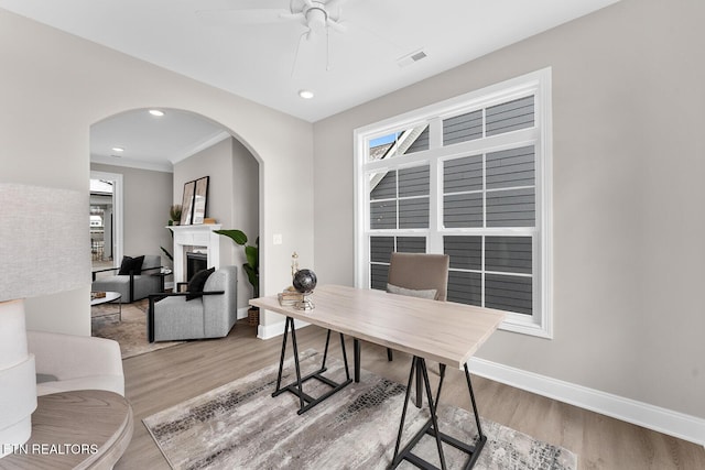 home office featuring visible vents, baseboards, and wood finished floors