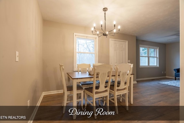 dining area with a healthy amount of sunlight, dark hardwood / wood-style flooring, and a chandelier