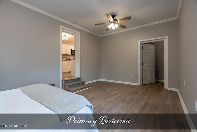 bedroom with crown molding, dark wood-type flooring, ceiling fan, and ensuite bath