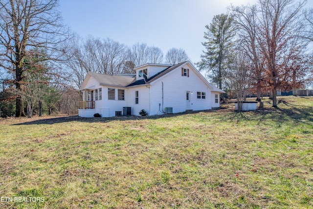 view of home's exterior featuring central AC and a lawn