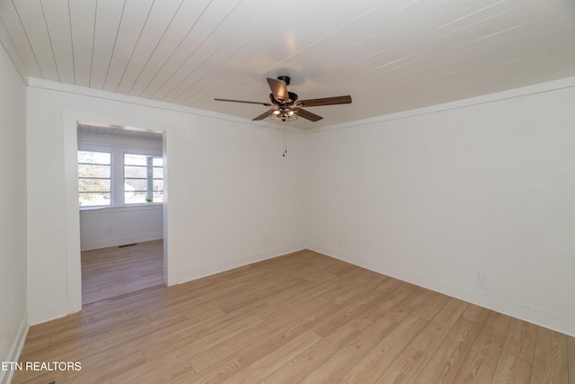 unfurnished room featuring ceiling fan, ornamental molding, wooden ceiling, and light wood-type flooring