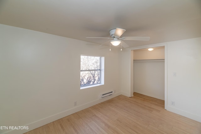 unfurnished bedroom featuring ceiling fan, light hardwood / wood-style floors, and a closet