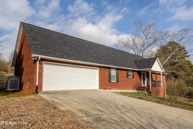 ranch-style house featuring central AC and a garage