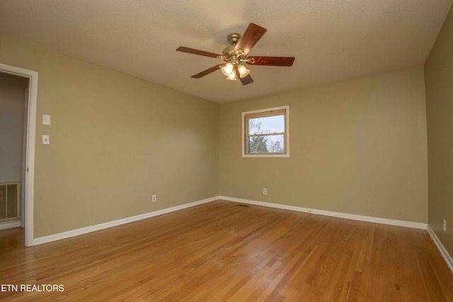 empty room featuring ceiling fan and light hardwood / wood-style flooring