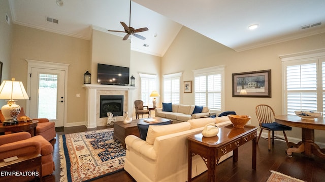 living room with crown molding, dark hardwood / wood-style floors, ceiling fan, and high vaulted ceiling