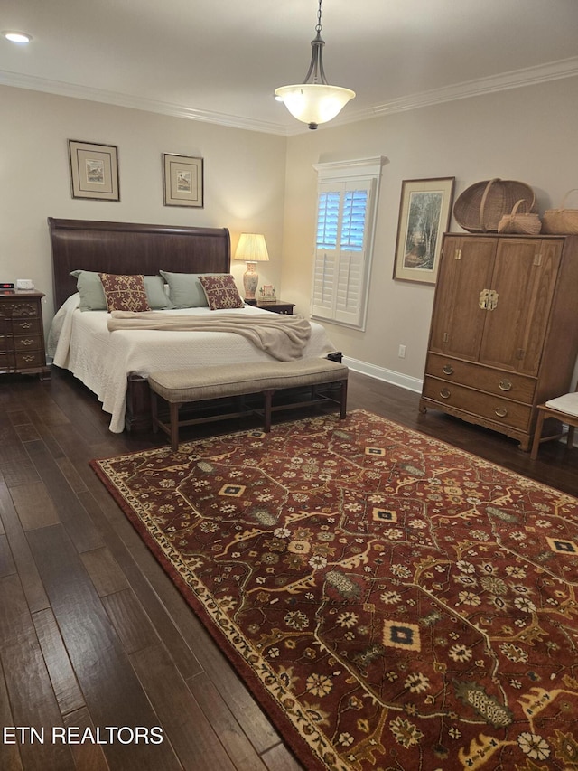 bedroom with ornamental molding and dark hardwood / wood-style flooring