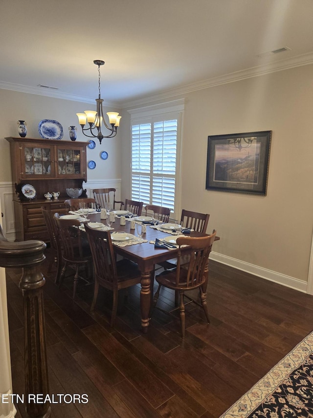 dining area with crown molding, a chandelier, and dark wood-type flooring