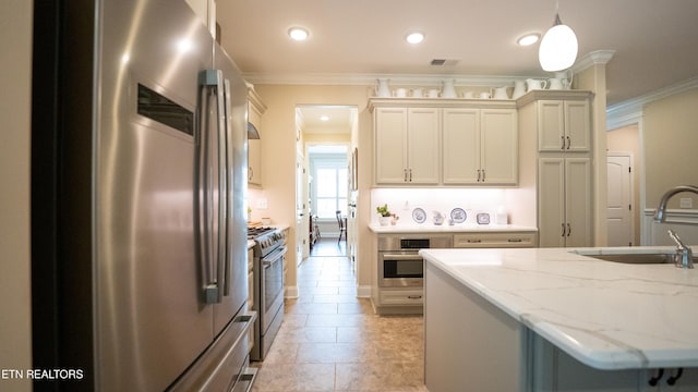 kitchen featuring sink, crown molding, stainless steel appliances, light stone countertops, and decorative light fixtures