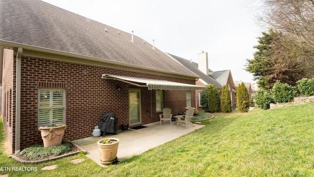 back of house featuring a yard and a patio area