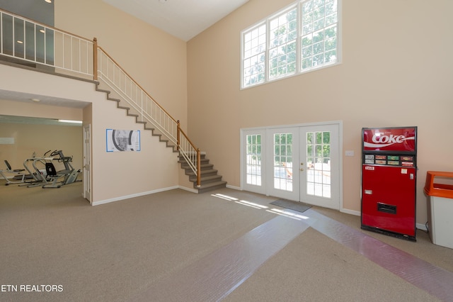 interior space with french doors and a high ceiling