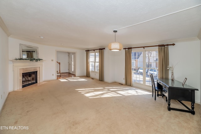 living room featuring light carpet, crown molding, a tile fireplace, and a textured ceiling