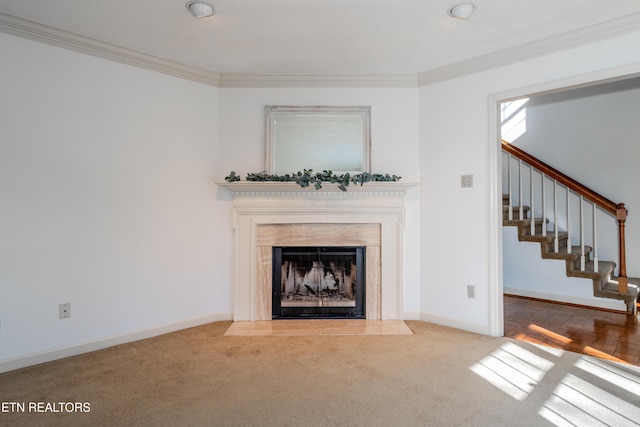 unfurnished living room with crown molding and carpet