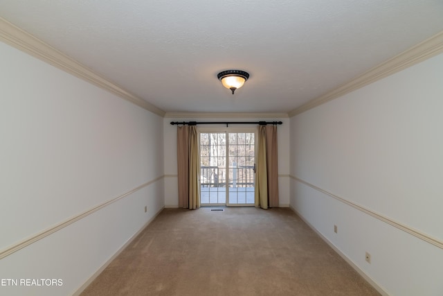 unfurnished room featuring ornamental molding, light colored carpet, and a textured ceiling