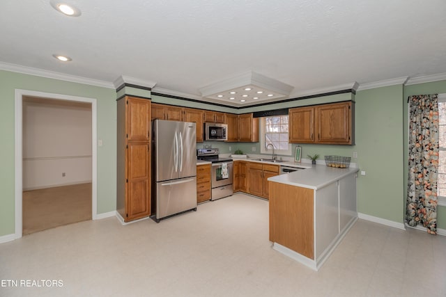 kitchen with sink, crown molding, a textured ceiling, appliances with stainless steel finishes, and kitchen peninsula