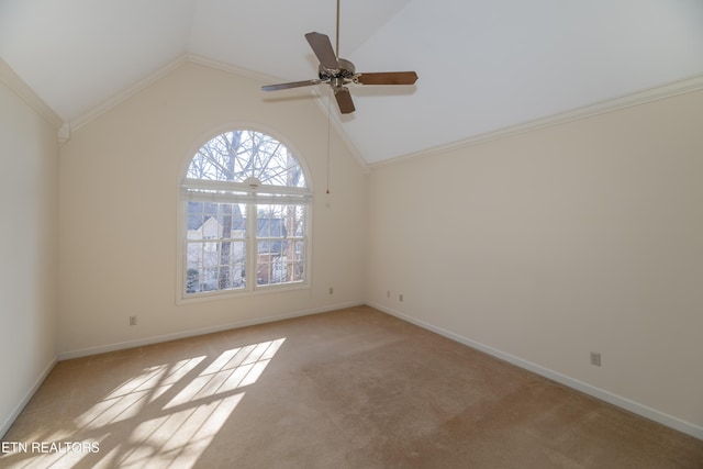 empty room with ceiling fan, light colored carpet, ornamental molding, and vaulted ceiling