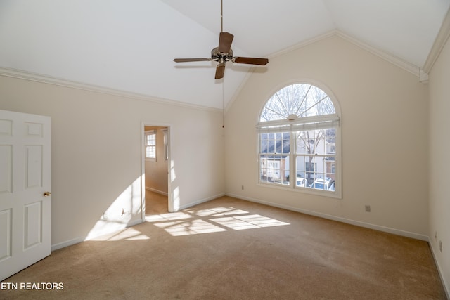 carpeted empty room featuring ceiling fan, ornamental molding, and high vaulted ceiling