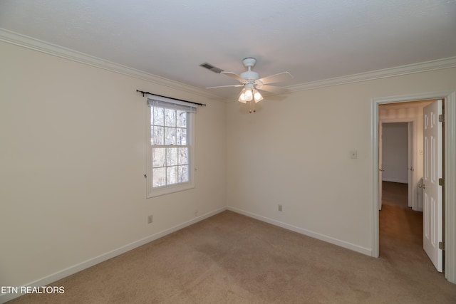 carpeted empty room featuring crown molding and ceiling fan