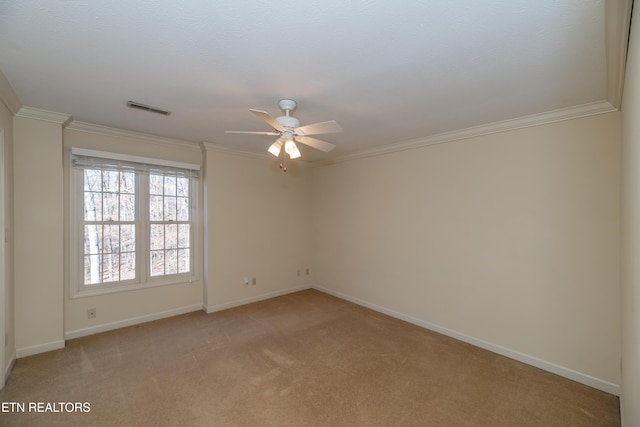 empty room with light carpet, crown molding, and ceiling fan