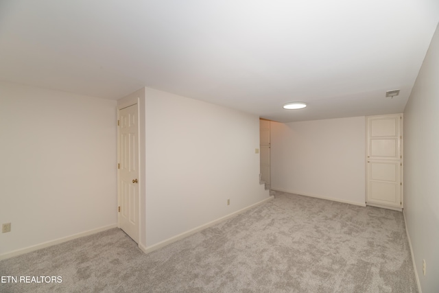 basement featuring light colored carpet