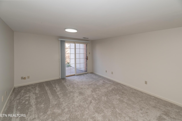 unfurnished room featuring light colored carpet