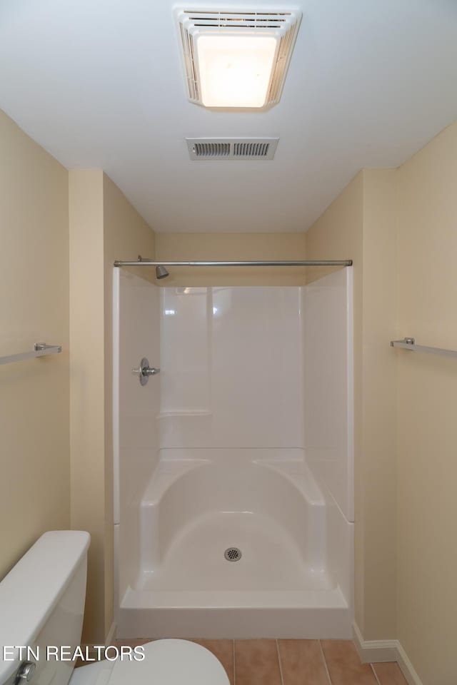 bathroom with toilet and walk in shower